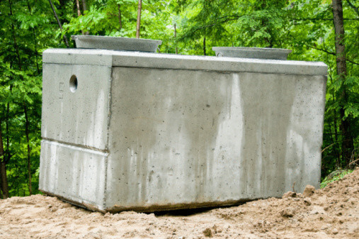Image of a concrete Septic Tank sitting above ground. These septic tanks can be inspected for leaks by Tim Frank Septic.